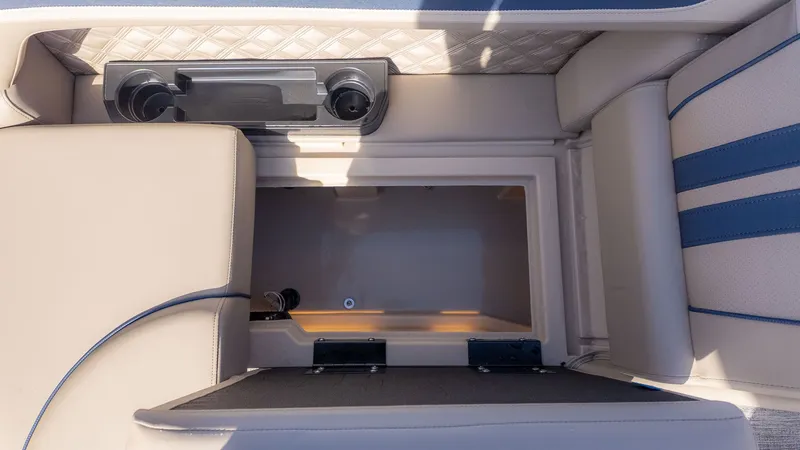 Slide: The Image of Interior view of a Bennington 22 S STERN RADIUS boat with storage compartment and cup holders. - 9