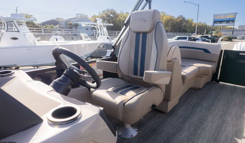 Slide: The Image of The image shows the cockpit of a 2026 Bennington 22 S STERN RADIUS boat with beige seats. - 10