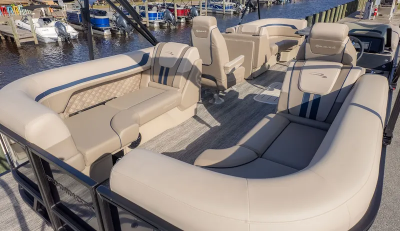 Slide: The Image of Luxurious pontoon boat with beige seating and blue accents, docked at a marina. - 4