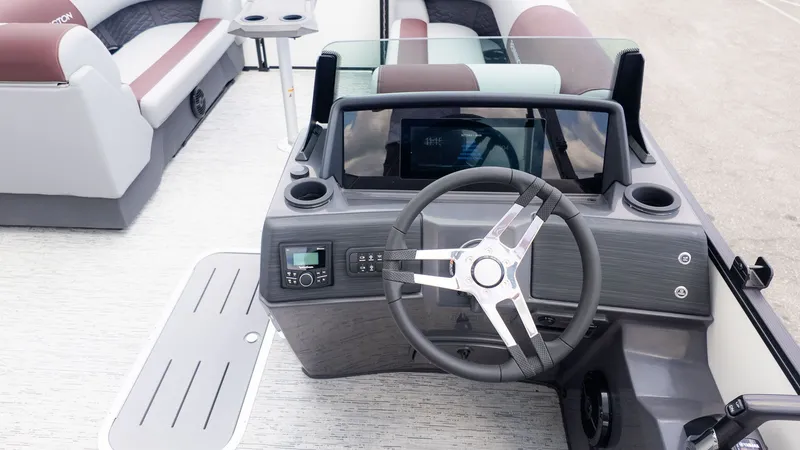 Slide: The Image of The image shows the cockpit of a Bennington 22 S Swingback boat with a modern steering wheel and instruments. - 17