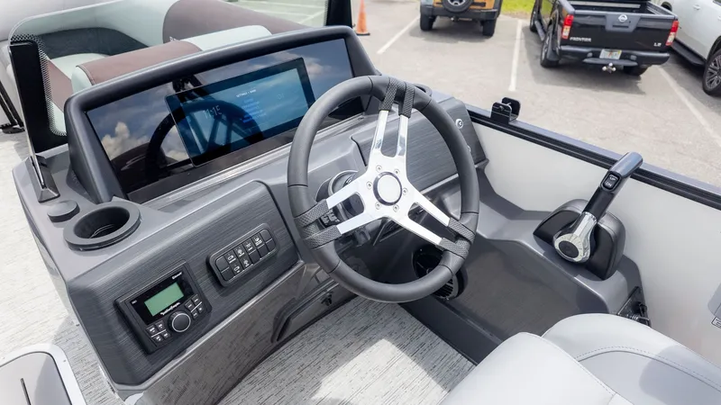 Slide: The Image of The image shows the helm of a Bennington 22 S Swingback boat with modern controls. - 16