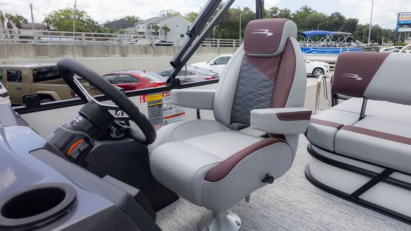 Slide: The Image of The 2026 Bennington 22 S Swingback features a sleek helm with a cushioned captain's chair. - 13