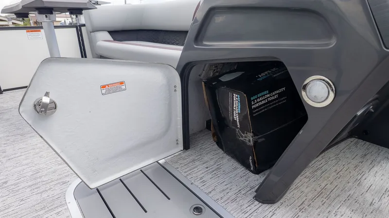 Slide: The Image of An open storage compartment on a boat with a box inside. - 12
