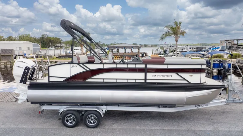 Slide: The Image of Bennington 22 S Swingback pontoon boat on a trailer at the dock. - 16