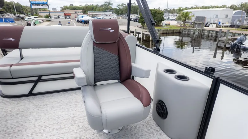 Slide: The Image of A sleek seat on a modern boat, surrounded by water and a dock in the background. - 5