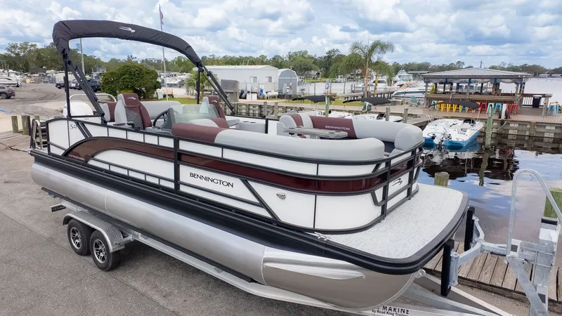 Slide: The Image of A Bennington 22 S Swingback pontoon boat on a trailer, ready for launch. - 18