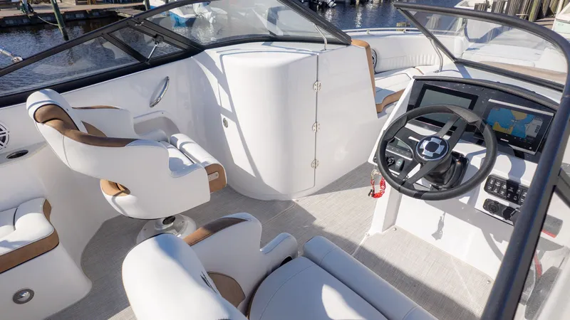 Slide: The Image of The image shows the cockpit of a Stingray 231 DC boat with modern seating and a helm station. - 13