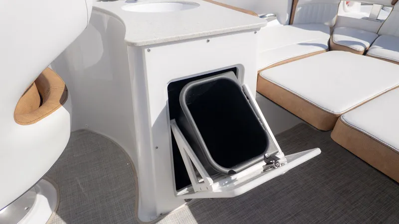 Slide: The Image of Interior of a boat with white seating area and storage compartment. - 8