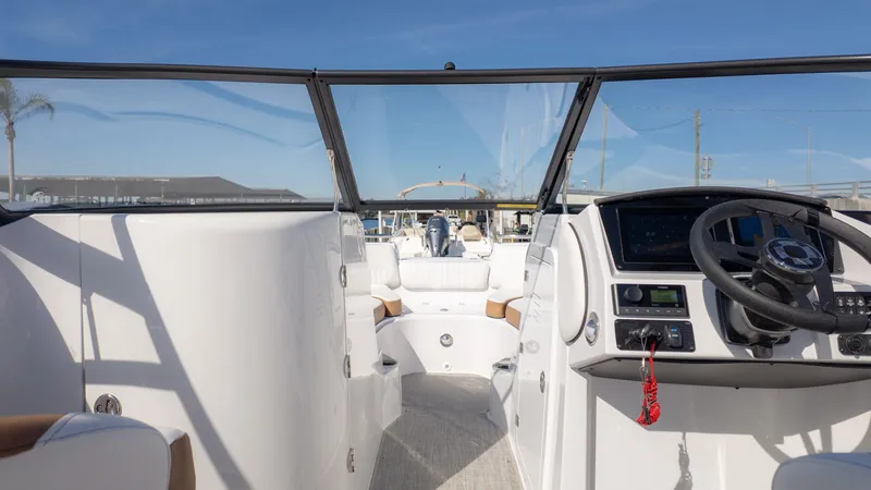 Slide: The Image of The image shows the cockpit of a modern boat with a helm and clear skies in the background. - 16