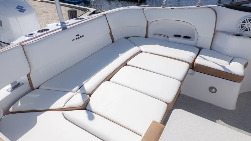 Slide: The Image of The image shows the luxurious white seating area of a Stingray 231 DC boat. - 9