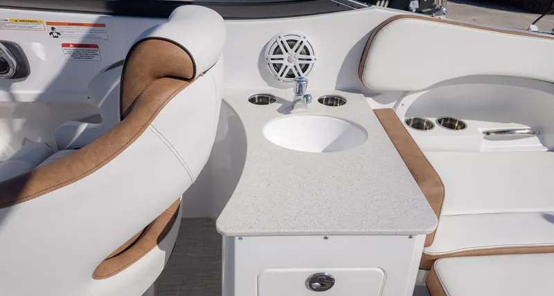 Slide: The Image of The image shows the cockpit of a Stingray 231 DC boat with a sink and seating. - 7