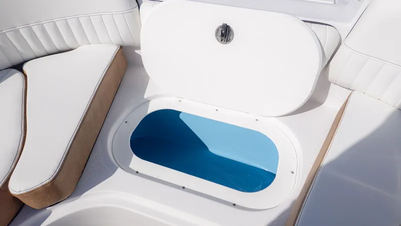 Slide: The Image of An open storage compartment on a boat with white upholstery and a blue interior. - 19