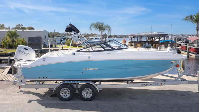 Slide: The Image of A 2026 Stingray 231 DC boat on a trailer, ready for launch. - 25