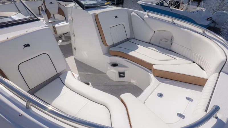 Slide: The Image of The image shows the cockpit of a Stingray 231 DC boat with white and beige seating. - 17