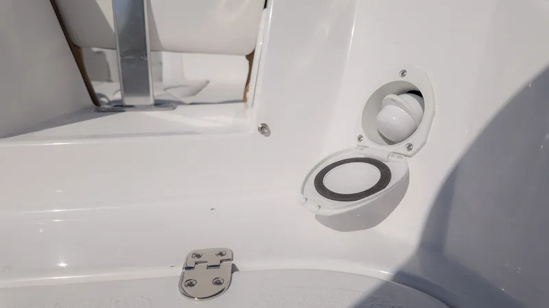 Slide: The Image of Close-up of a white boat deck with an open round cover and a hinge. - 4