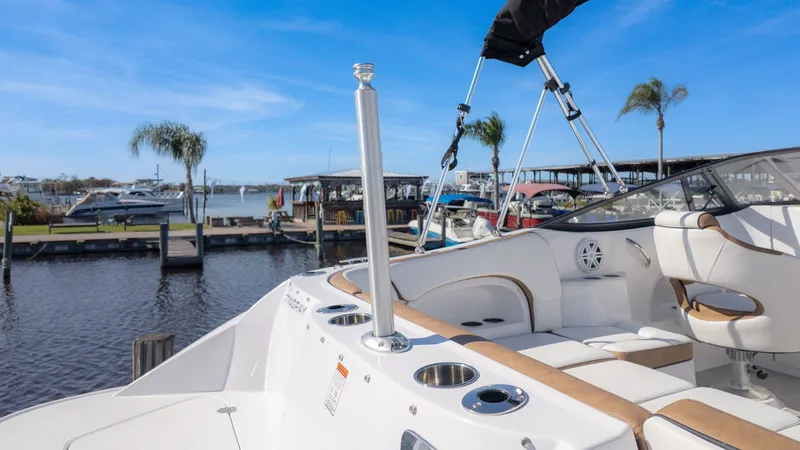 The Image of The image shows a modern boat docked, overlooking the water and palm trees. - 1