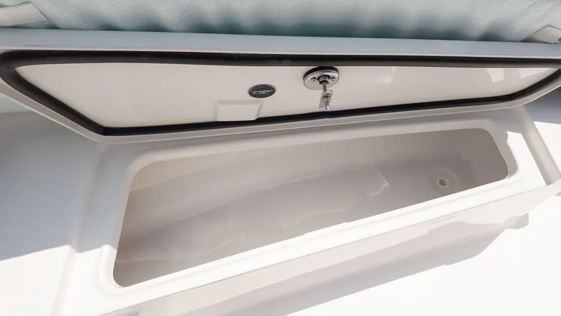 Slide: The Image of An open storage compartment on a Tidewater 210 LXF boat, revealing a spacious interior. - 17
