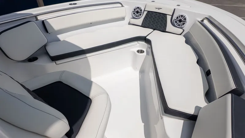 Slide: The Image of The image shows the bow area of a modern boat with white upholstery and speakers. - 15