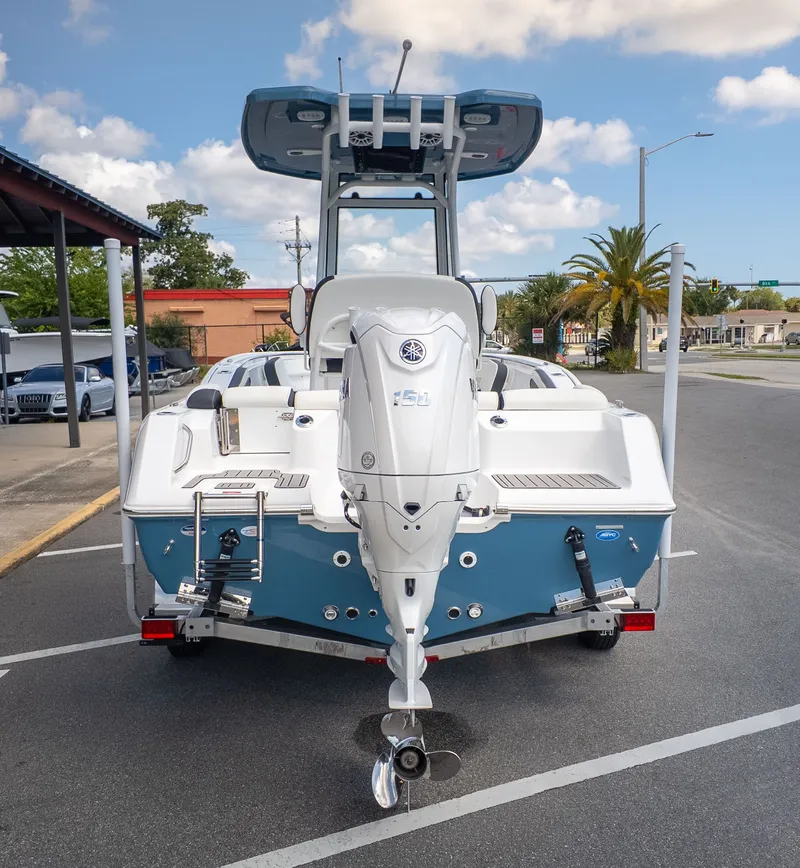 Slide: The Image of The image shows a Tidewater 210 LXF boat in a parking lot. It features an outboard motor. - 4