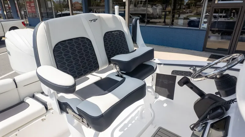 Slide: The Image of The 2027 Tidewater 210 LXF features luxurious padded seating and a modern helm console. - 8