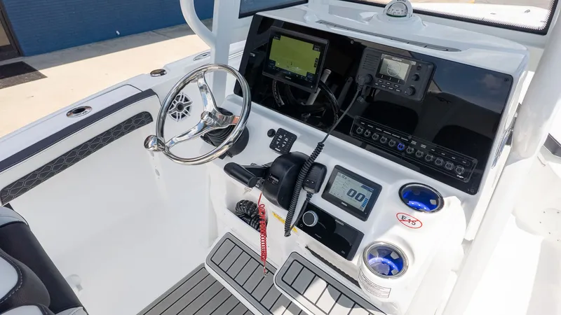 Slide: The Image of The image shows the helm of a Tidewater 210 LXF boat with modern instruments. - 11
