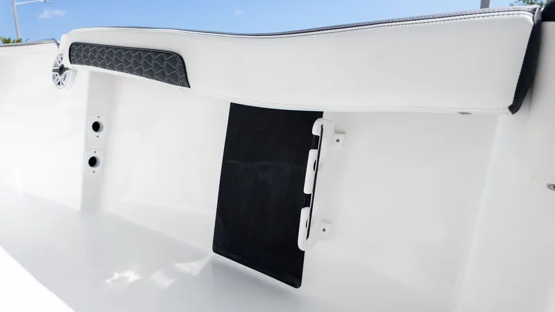 Slide: The Image of Close-up of a white boat seat with black padding and a bracket. - 5