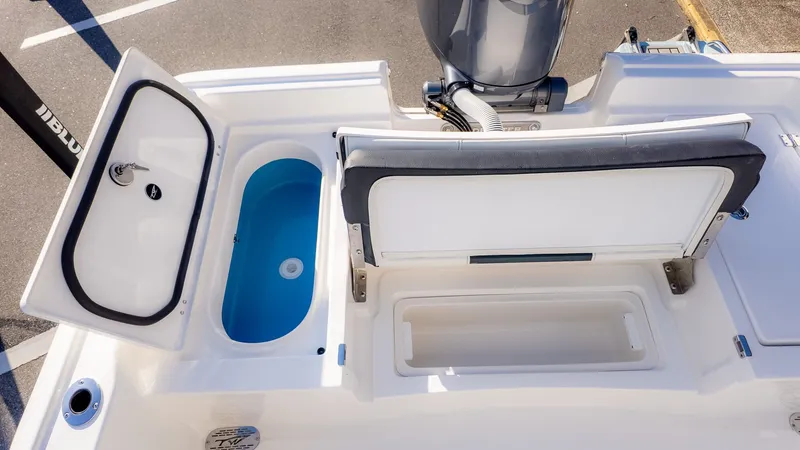 Slide: The Image of The image shows the stern of a Tidewater 2210 Carolina Bay boat with an engine and storage compartments. - 7