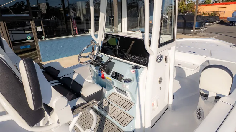 Slide: The Image of The image shows the cockpit of a Tidewater 2210 Carolina Bay boat with modern equipment. - 10