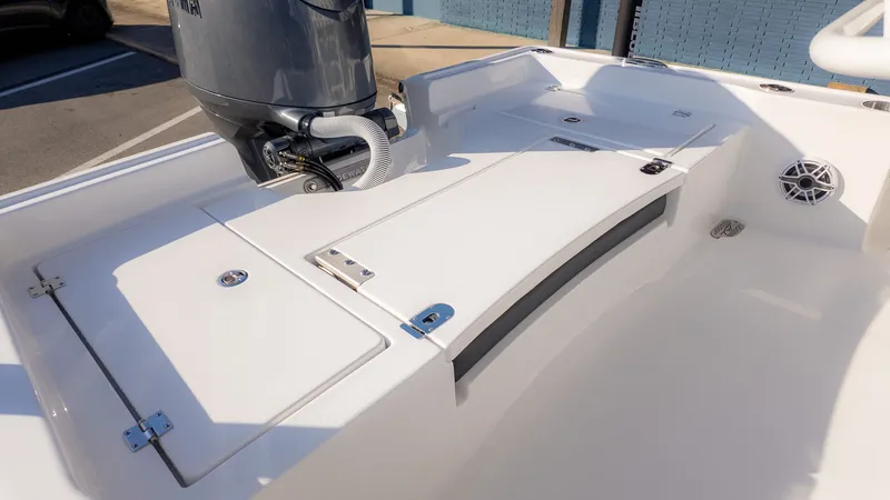 Slide: The Image of The image shows the deck of a Tidewater 2210 Carolina Bay boat with an outboard motor. - 5