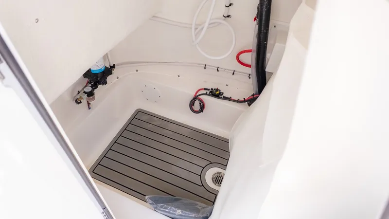 Slide: The Image of Interior view of a boat with gray flooring and white walls. - 22