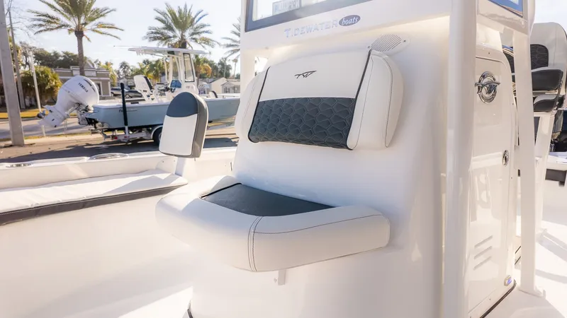 Slide: The Image of The image shows the cockpit of a Tidewater 2210 Carolina Bay boat with comfortable seating. - 20