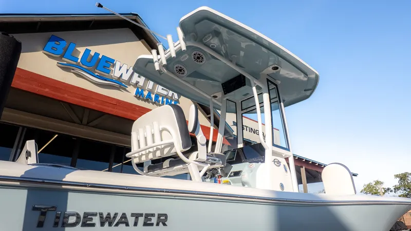 Slide: The Image of A Tidewater 2210 Carolina Bay boat in front of a building with "Bluewater Marine" signage. - 23