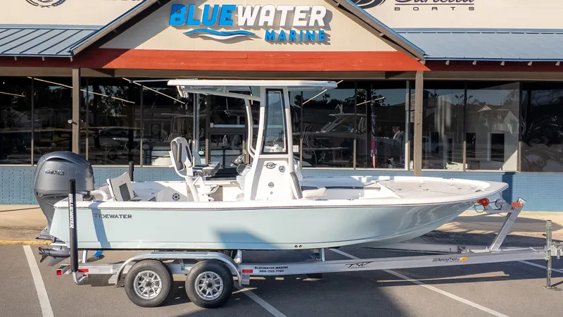 Slide: The Image of A Tidewater 2210 Carolina Bay boat on a trailer in front of a marine store. - 21