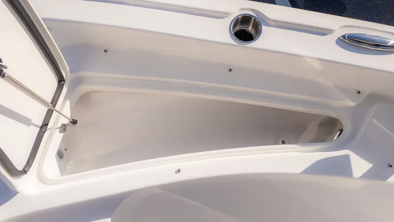 Slide: The Image of The image shows an open storage compartment on a boat with a stainless steel handle and cup holder. - 16