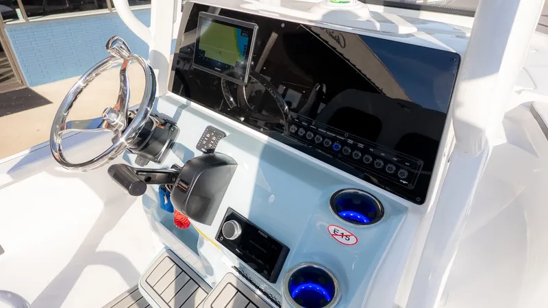 Slide: The Image of The image shows the helm of a Tidewater 2210 Carolina Bay boat with modern instruments. - 10