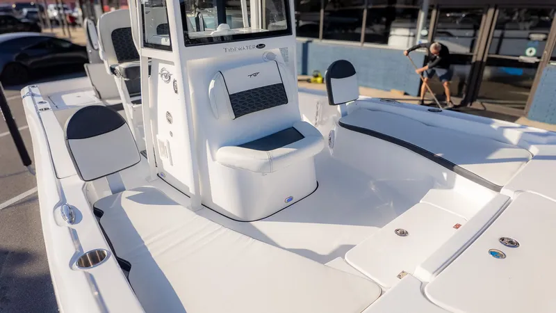 Slide: The Image of The image shows the deck of a Tidewater 2210 Carolina Bay boat with seating and a helm console. - 14
