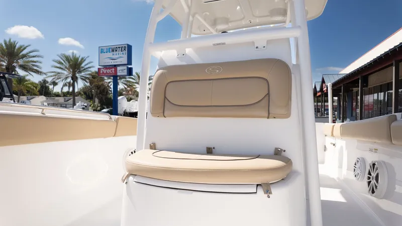 Slide: The Image of The image shows the cockpit of a Sportsman 251 Heritage boat with beige seating. - 19