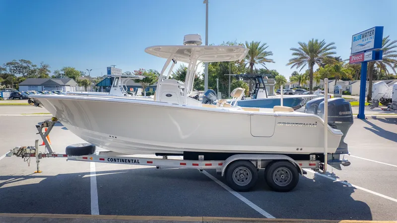 Slide: The Image of A 2014 Sportsman 251 Heritage boat on a trailer in a parking lot. - 3