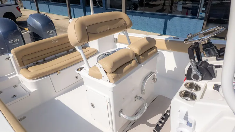 Slide: The Image of The image shows the cockpit of a 2014 Sportsman 251 Heritage boat with beige seating. - 5