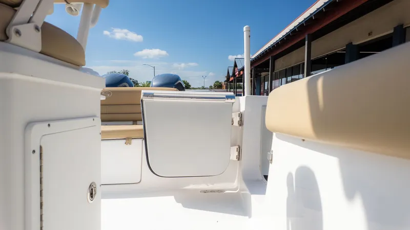 Slide: The Image of The image shows the cockpit of a Sportsman 251 Heritage boat with beige seats and blue sky. - 12