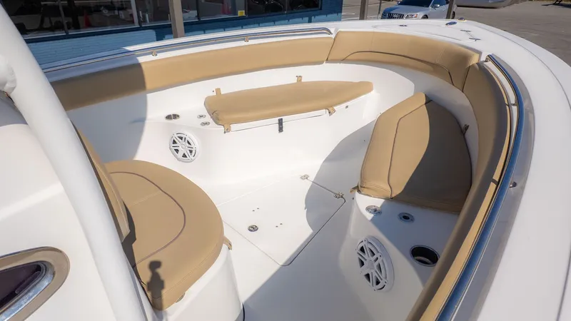 Slide: The Image of The image shows the bow area of a Sportsman 251 Heritage boat with beige cushions. - 6