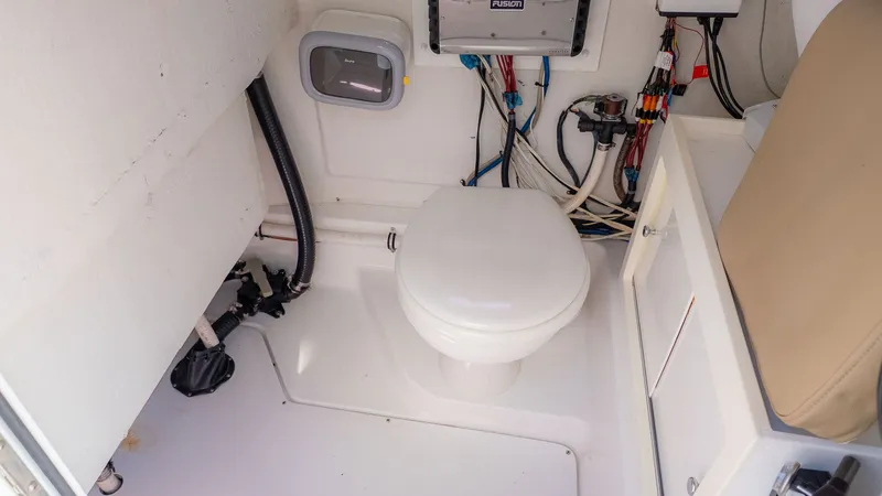 Slide: The Image of Boat interior with a toilet and technical connections visible. - 20