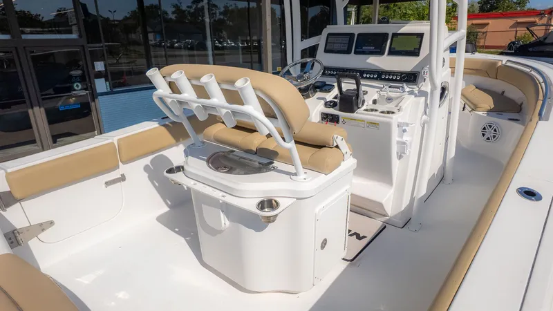Slide: The Image of The image shows the cockpit of a 2014 Sportsman 251 Heritage boat with beige seats and helm. - 3