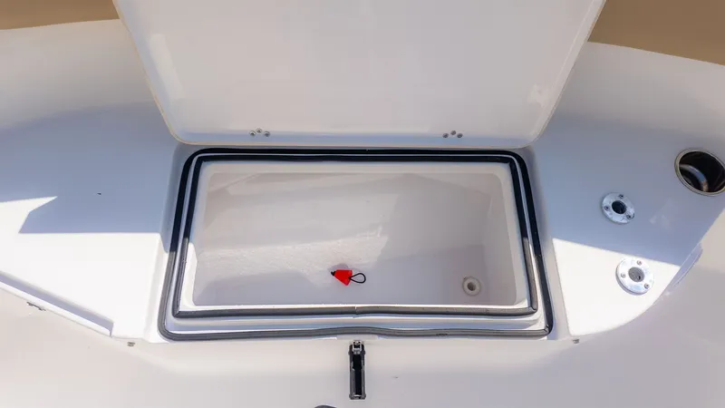 Slide: The Image of An open storage compartment on a 2014 Sportsman 251 Heritage boat. - 15