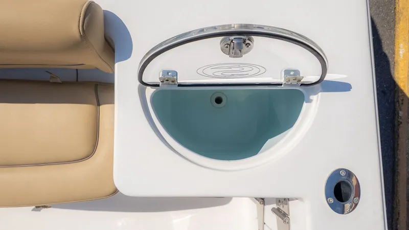 Slide: The Image of An open compartment on a boat with beige seating and stainless steel fittings. - 9