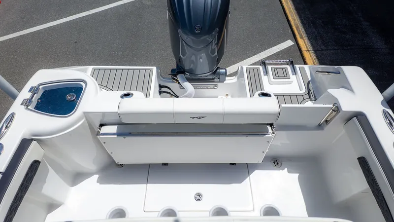 Slide: The Image of The image shows the stern of a Tidewater 220 CC Adventure boat with an outboard motor. - 3