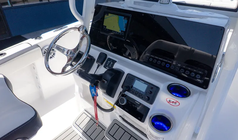 Slide: The Image of The image shows the cockpit of a Tidewater 220 CC Adventure boat with modern electronics. - 14