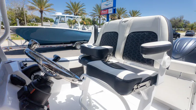 Slide: The Image of The image shows the helm of a Tidewater 220 CC Adventure boat with cushioned seats. - 13