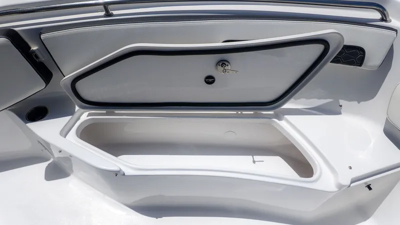 Slide: The Image of The image shows an open storage compartment on a boat, with a gray lid and a lock. - 12