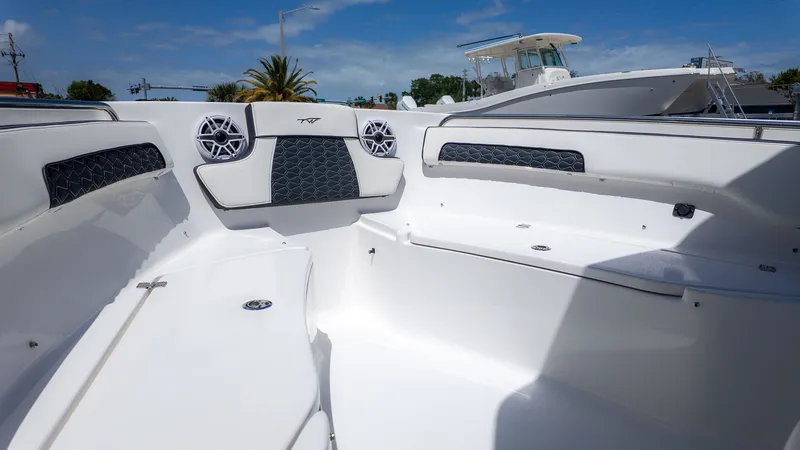 Slide: The Image of The image shows the cockpit of a Tidewater 220 CC Adventure boat with white seating and speakers. - 8